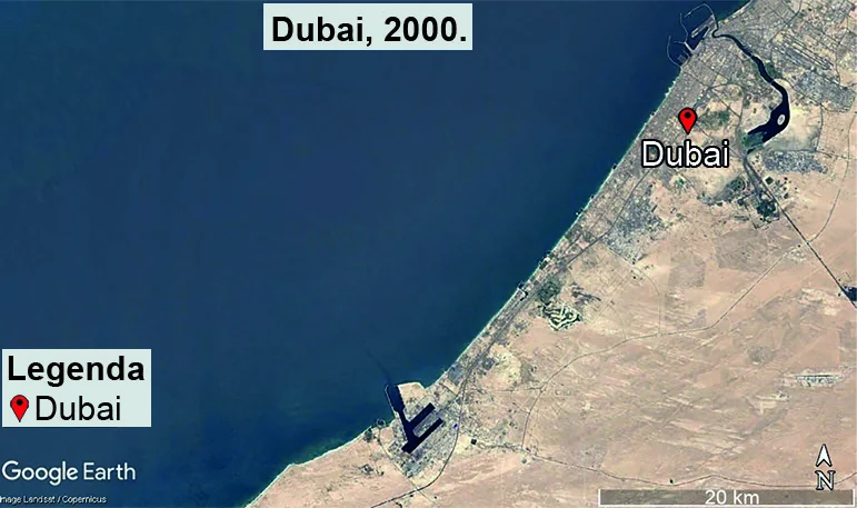 Imagem de satélite da região de Dubai no ano 2000, mostrando a linha de costa praticamente contínua e regular, com mancha urbana restrita e ausência de ilhas artificiais no mar. Legenda indica o ponto Dubai e escala de 20 km