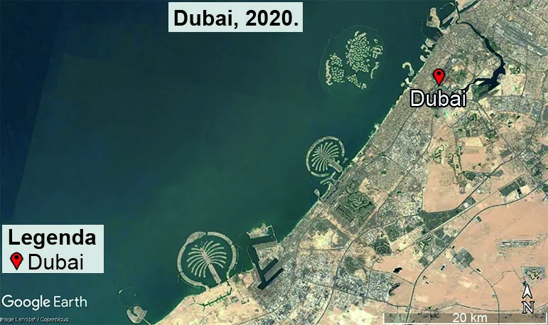 Imagem de satélite da mesma região de Dubai no ano 2020, mostrando grandes ilhas artificiais construídas no mar, com formato de palmeira e de arquipélago, além de expressiva expansão da mancha urbana ao longo da costa. Legenda indica o ponto Dubai e escala de 20 km